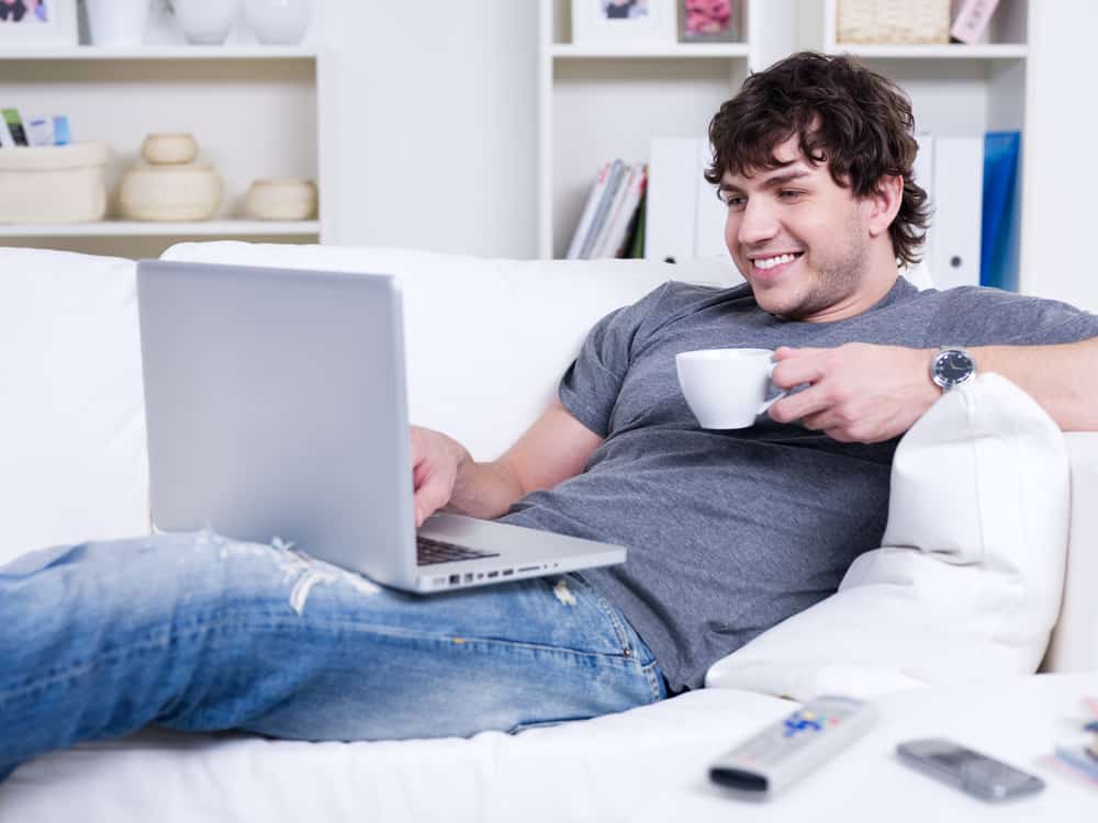 Man with laptop and cup of coffee